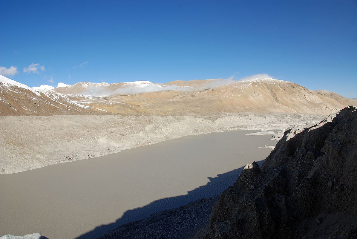 15 Glacial Lake On Gyabrag Glacier Just Before Cho Oyu Intermediate Camp As we drive from Chinese Base Camp (4908m) near Intermediate Camp, the road is directly above a large glacial lake. The two mountains in the distance are Labuche Kang and Lobuche Kang III E.